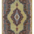 A Qaleen Carpets rug with a central, intricate design and a border of similar patterns, set against a pale yellow background