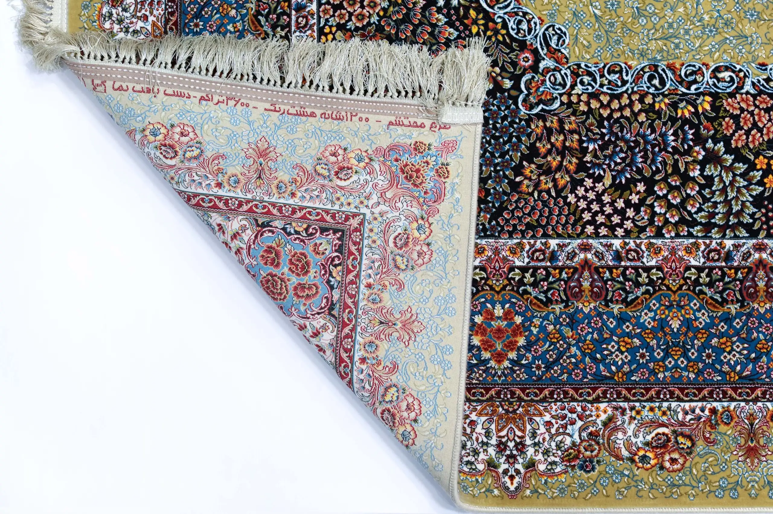 A Qaleen Carpets rug with a mix of patterns and colors, including flowers and leaves, with a fringe at the top and a corner