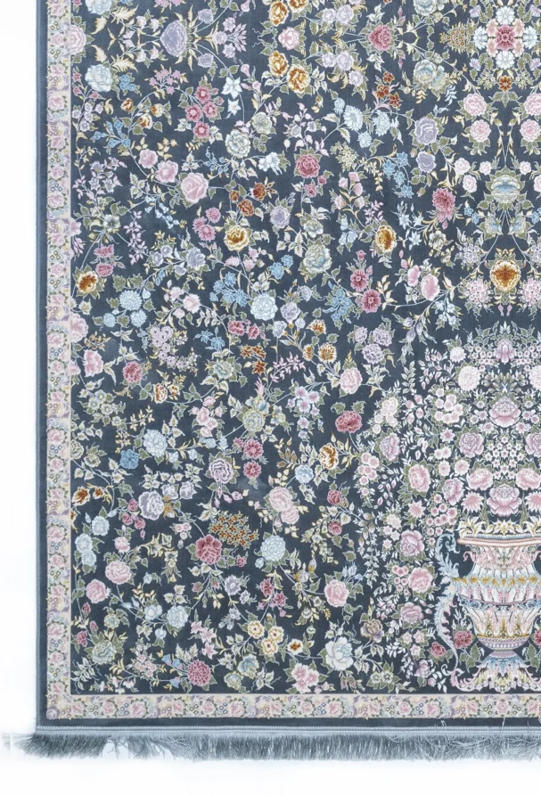 A Qaleen Carpets rug with a dark blue background and a floral pattern of various flowers and leaves in pastel colors, with a