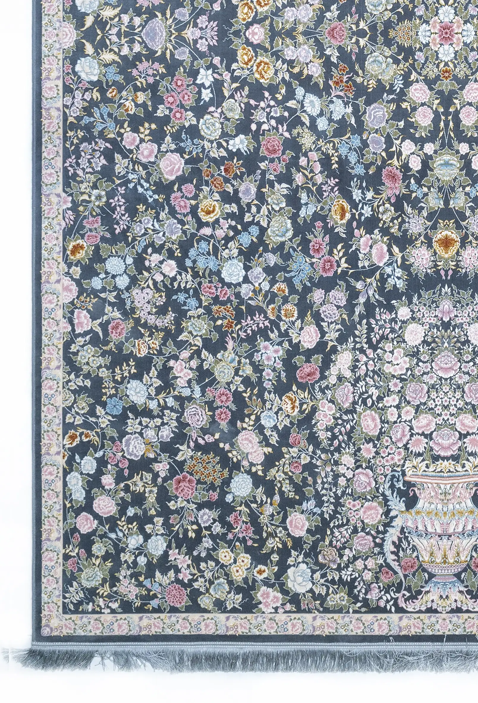 A Qaleen Carpets rug with a dark blue background and a floral pattern of various flowers and leaves in pastel colors, with a
