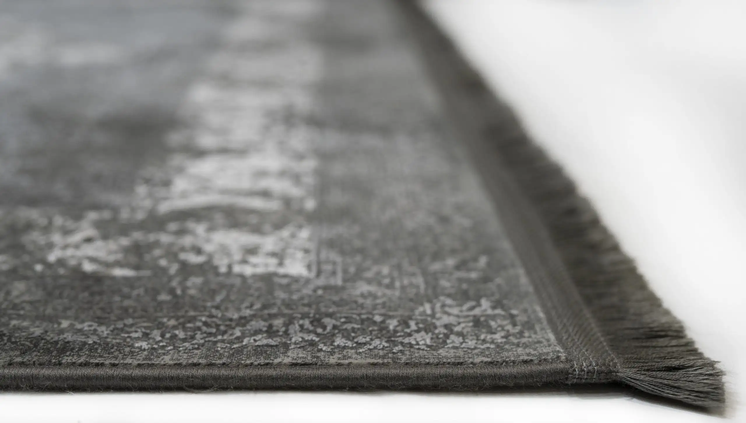 Carpets A close-up of a carpet's edge, with a focus on the intricate pattern and the soft, fluffy texture of the carpet's
