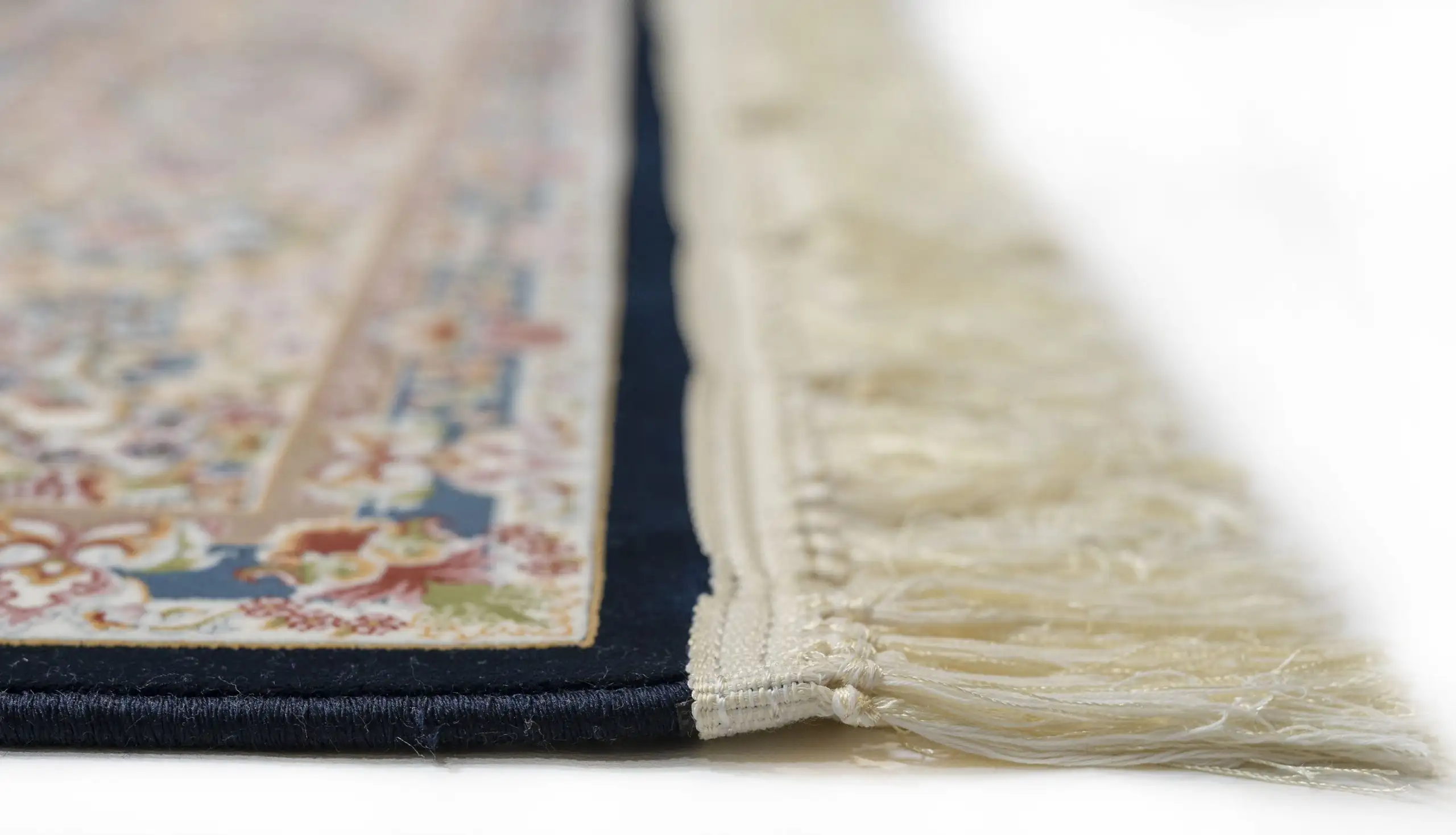 A close-up of a rug's edge, with a focus on the intricate carpeting and rug design, showcasing the beauty of carpets and rugs