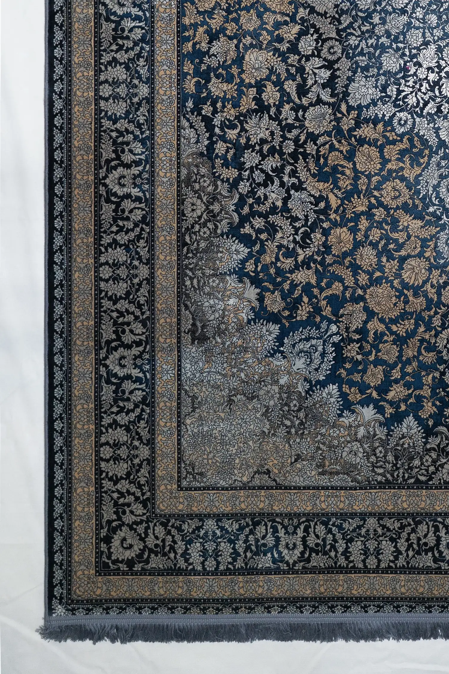 Carpets A beautiful, intricately designed carpet with a rich, dark blue background and intricate gold and silver patterns