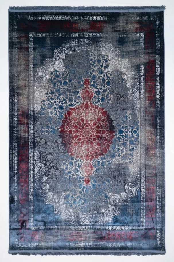 Carpets A rug with a faded, distressed look, with a central red and blue pattern surrounded by a white border