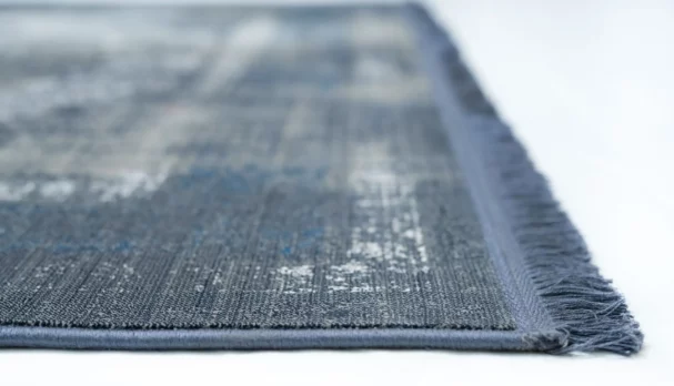 A close-up view of a Qaleen Carpets rug, showcasing its intricate design and texture