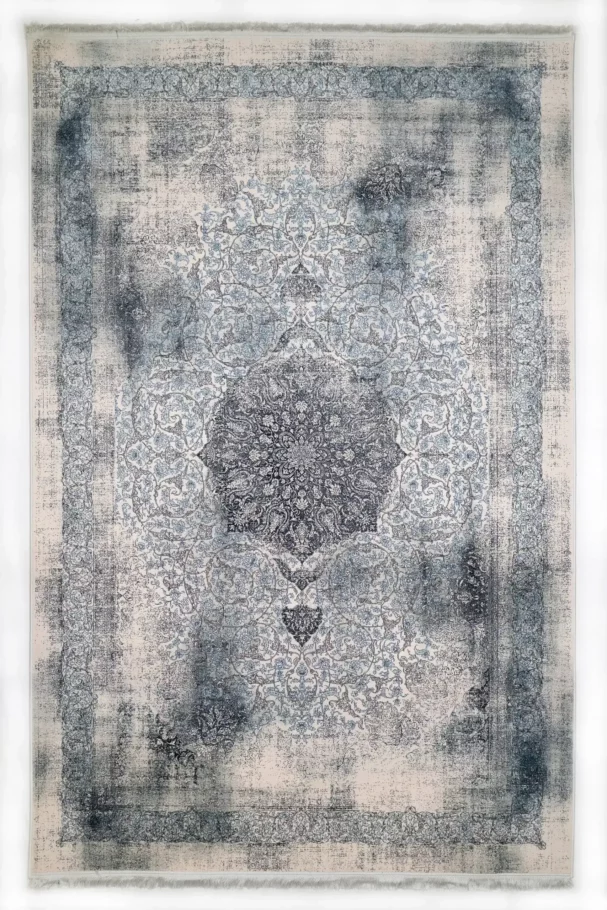 A Qaleen Carpets rug with a central medallion and intricate border, featuring a mix of blue and white patterns on a cream