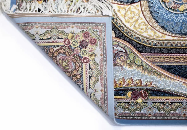 Carpets A beautiful, intricately designed carpet with a mix of colors and patterns, with a corner folded and a part of the