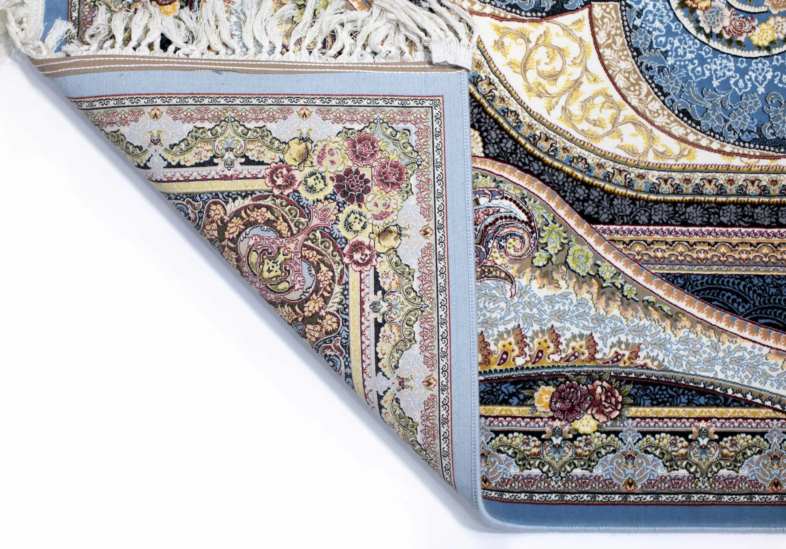 Carpets A beautiful, intricately designed carpet with a mix of colors and patterns, with a corner folded and a part of the
