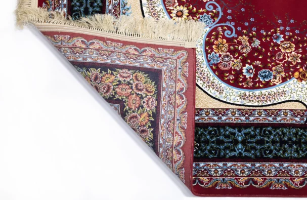 A Qaleen Carpets rug with a red, floral patterned design, partially unrolled to show its intricate details