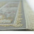 A close-up view of a Qaleen Carpets rug, with its intricate design and frayed edges on a white background