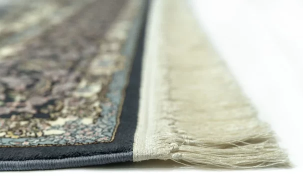 A close-up view of a Qaleen Carpets rug, focusing on its intricate design and fringe details