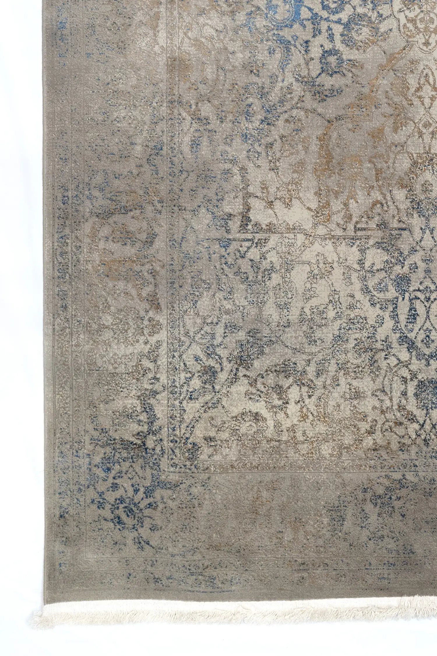 A close-up of a Qaleen Carpets rug with a traditional, intricate design and a soft, muted color palette