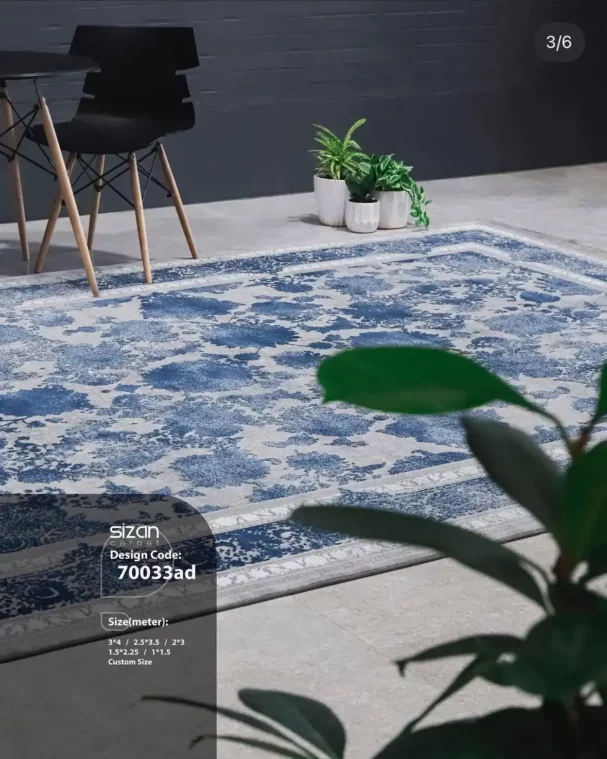 Carpets A beautiful, blue and white, patterned carpet on a grey floor, with a chair and a plant in the background