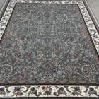 Carpets A large, intricately patterned carpet with a central grey area surrounded by a white border, with a mix of red,