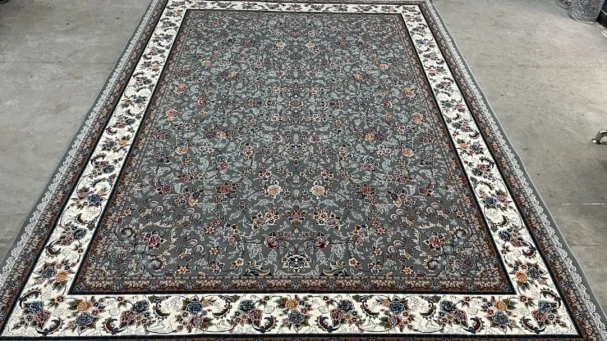 Carpets A large, intricately patterned carpet with a central grey area surrounded by a white border, with a mix of red,
