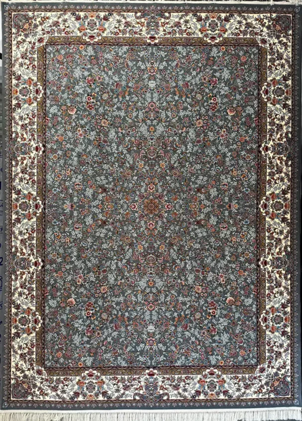 A Qaleen Carpets rug with a gray background and intricate floral pattern, featuring a border of white and gold, and a fringe