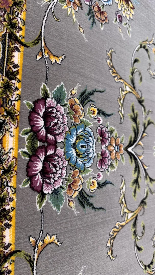 Carpets A close-up of a carpet with a floral pattern, featuring a mix of colors and a soft, carpeted texture