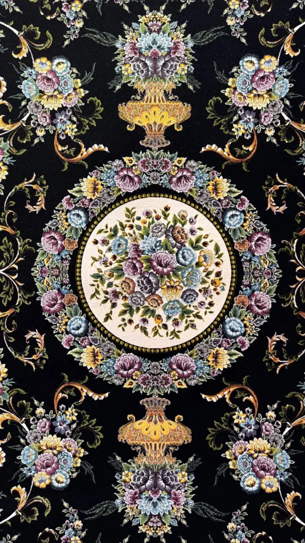 Carpets A beautiful, intricately designed carpet with a central floral pattern surrounded by a border of flowers and leaves,